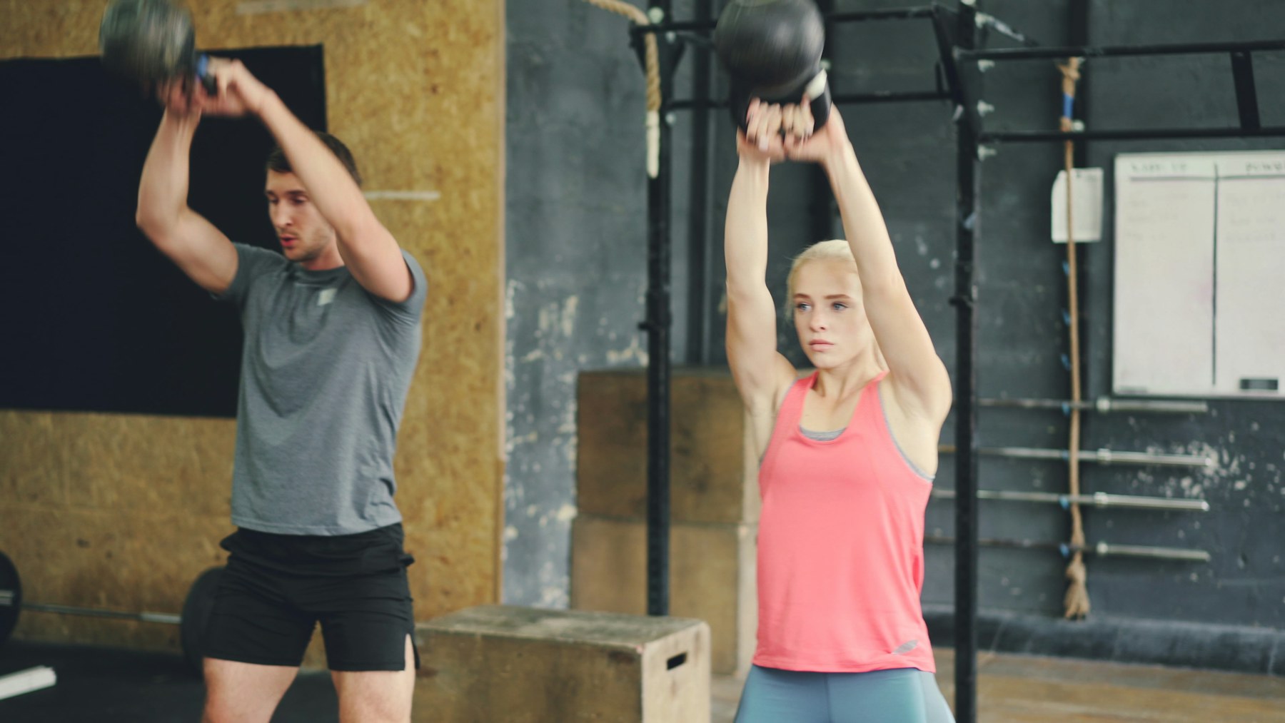 Athletes performing kettlebell swings in a gym